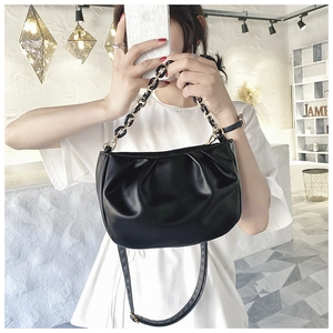 Detailed view of black cloud bag featuring pleated PU leather and chunky chain strap