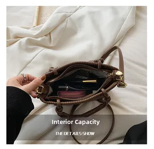 Internal view of brown pleated bucket bag showing large capacity and zipper closure