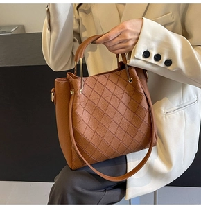 Brown lychee leather tote bag featuring classic diamond quilting and gold hardware