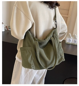 Detailed view of dark green corduroy tote bag showing large capacity and adjustable strap