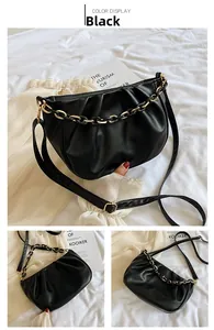 Detail view of black ruched cloud bag featuring elegant gold chain and soft PU leather