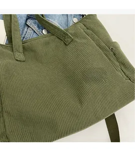 Detail of army green corduroy tote bag showing thick ribbed texture and dual straps