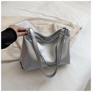 Detail of silver metallic leather tote bag with chain strap and soft pleated texture
