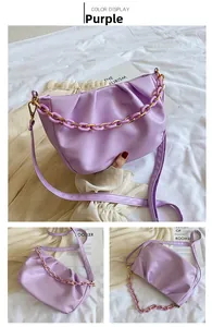 Detail view of purple cloud pleated bag with thick chain handle and leather strap