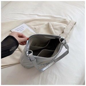 Detail view of silver tote bag interior with double slip pockets and zipper closure