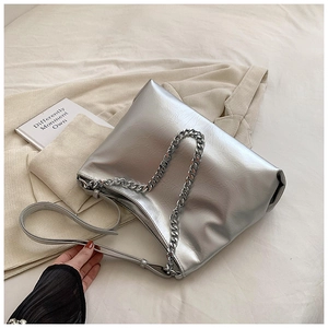 Detailed shot of silver metallic leather tote bag with thick chain and adjustable strap