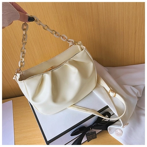 Detail of creamy white cloud bag featuring soft pleated PU leather and gold metal chain