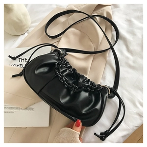 Détail du sac nuage noir plissé en cuir mat avec chaîne épaisse et cordon de serrage