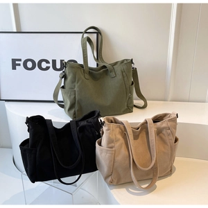 Three corduroy tote bags in green black and beige showing textured fabric and dual straps