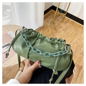 Détail du sac nuage plissé vert avocat avec grosse chaîne acrylique et bandoulière