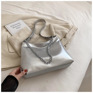 Detailed shot of silver metallic leather handbag with chain and adjustable strap