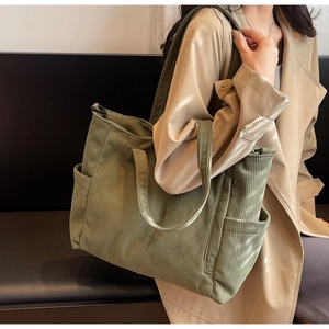 Olive green corduroy tote bag detail showing side pocket and soft fabric texture on shoulder