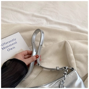 Detail of silver metallic tote bag showing premium mirror leather and chain strap