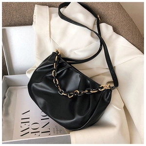 Detail of black pleated cloud bag featuring textured PU leather and a chunky chain strap