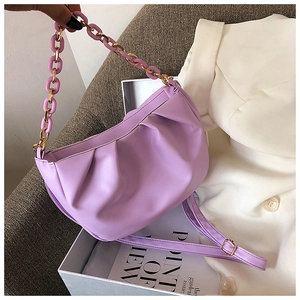 Detail of lilac pleated dumpling bag with chunky acrylic and gold metal chain strap