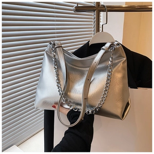 Detail of silver metallic tote bag with chunky chain strap and textured soft leather