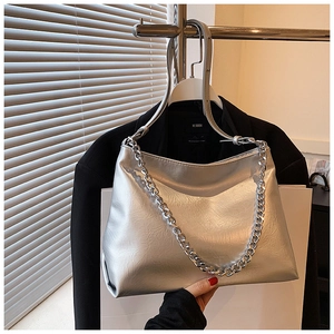 Detail of silver metallic textured leather tote with chunky chain and shoulder strap