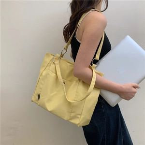 Bright yellow large canvas tote bag for women showing spacious interior for laptops