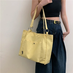 Large yellow canvas tote bag with front pocket for casual commute and daily use
