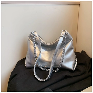 Detail of silver metallic tote bag featuring luxury chain strap and soft leather texture