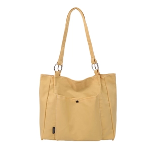 Large yellow canvas tote bag with metal ring handles and functional front pocket
