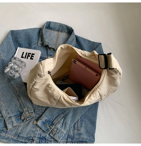 Top-down view of spacious nylon tote bag with zipper and pink tablet inside