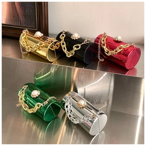 Macro detail of acrylic mirror cylinder evening bags with pearl clasps and chain straps