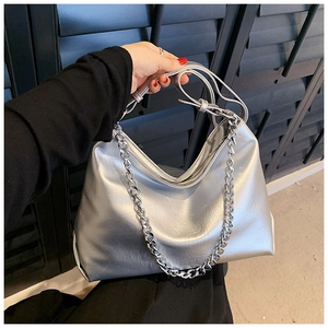 Close-up of silver hobo bag with chunky metal chain and soft metallic leather texture