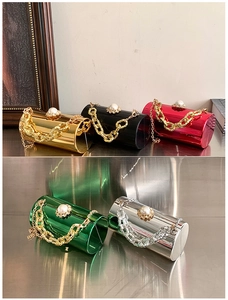 Macro detail of acrylic mirror cylinder evening bags with pearl rhinestones and gold chains