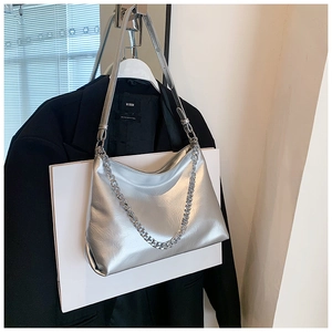 Detail of silver metallic hobo bag featuring crinkled patent leather and chunky chain