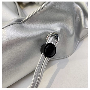 Macro shot of silver metallic leather texture with metal eyelet and drawstring buckle detail