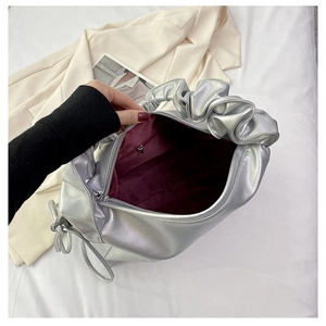 Silver pleated bag detail showing burgundy lining and inner zipper pocket compartment