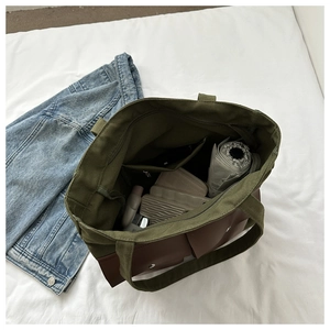 Detail of spacious interior with zipper pocket and metal snap front pockets of canvas tote
