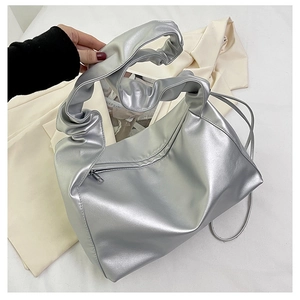 Detailed view of silver metallic pleated hobo bag with zip pocket and ruched handle