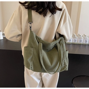 Olive green corduroy tote bag showing spacious design and durable side pocket detail