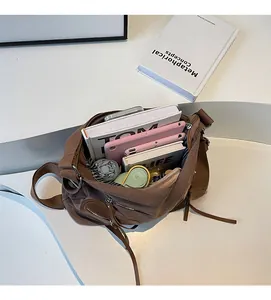 Spacious interior of brown canvas backpack showing storage for books and tablets