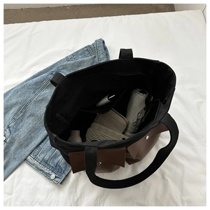 Top view of large canvas tote bag showing interior compartments and daily essentials