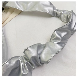 Close-up of the silver metallic ruched shoulder strap with detailed pleated texture