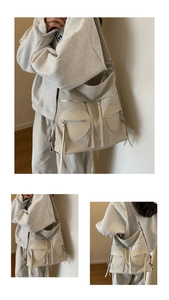Detail of cream corduroy tote featuring heart-shaped pockets and tassel zip accents
