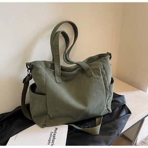 Detail of army green corduroy tote bag featuring striped texture and side pocket