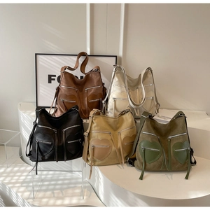 Detail view of retro corduroy backpacks in five colors with heart stitching and zippers