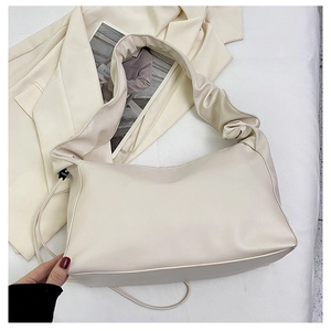 Chic beige ruched shoulder bag detail with minimalist pleated strap and PU leather texture