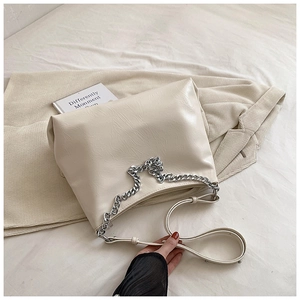 Detail of cream white PU leather tote with silver chain and soft pleated texture