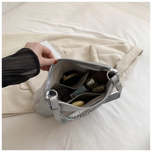 Macro view of interior storage and pockets of the silver metallic chain tote bag