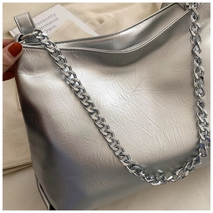 Detailed macro view of the silver metallic tote bag with wrinkled leather and chain