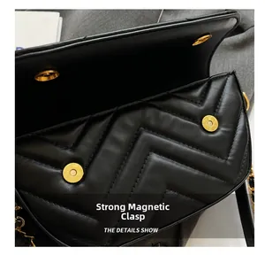 Detail showing the secure magnetic closure and gold hardware of the quilted black shoulder bag