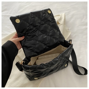 Dettaglio dell'interno spazioso e del materiale trapuntato della borsa a catena nera