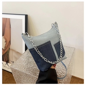 Detail of vintage denim patchwork shoulder bag with silver chain and pockets
