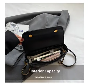 Detail shot of the black quilted crossbody bag showing spacious interior for a phone and wallet