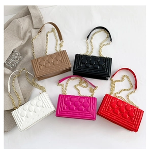 Flat lay of small rectangular chain bags in five vibrant colors with quilted texture